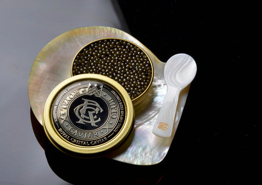 caviar next to the spoon of mother of pearl  